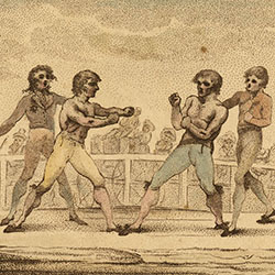 Two bare-chested white men, one in blue tights, one in yellow tights, boxing Two men stand by them. Crowd  behind fence watches.